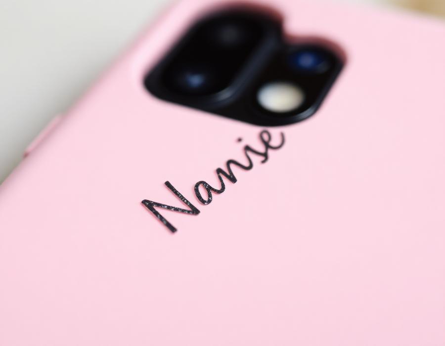 Close-up of personalised name detail on a pink phone case